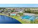 An aerial showcases the community's pool, clubhouse, tennis/pickleball courts, set by a beautiful lake at 284 Talquin Ct, Englewood, FL 34223