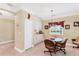 Charming breakfast nook features a glass top table, comfortable seating and bright natural light at 284 Talquin Ct, Englewood, FL 34223