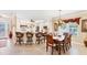 Charming dining room with wood table and seating for six adjacent to kitchen at 284 Talquin Ct, Englewood, FL 34223