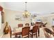 Open dining room with decorative lighting and wicker seating at 284 Talquin Ct, Englewood, FL 34223