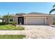 Welcoming single-Gathering home boasting a two-car garage, paver driveway, and well-maintained lawn with lush landscaping at 284 Talquin Ct, Englewood, FL 34223