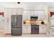 Modern kitchen featuring granite countertops, stainless steel appliances, and white cabinets at 284 Talquin Ct, Englewood, FL 34223