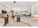 Modern kitchen with white cabinets, granite countertops, stainless steel appliances, and an open view to the dining area at 284 Talquin Ct, Englewood, FL 34223