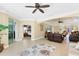 Open concept living room with comfortable seating, tile floors, and sliding glass doors to the bedroom at 284 Talquin Ct, Englewood, FL 34223