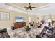 Spacious living room with neutral tones, tray ceiling, ceiling fan, and an open layout perfect for entertaining guests at 284 Talquin Ct, Englewood, FL 34223