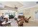 Inviting living room with tray ceiling, ceiling fan, neutral tones, and a large window overlooking the lush backyard at 284 Talquin Ct, Englewood, FL 34223