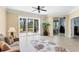 Bright living room with access to the patio, stylish rug, and comfortable seating at 284 Talquin Ct, Englewood, FL 34223