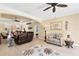 Spacious living room with ceiling fans, neutral tones, tile flooring, and stylish decor at 284 Talquin Ct, Englewood, FL 34223