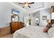 Main bedroom features tray ceilings, light-colored walls, hardwood floors and TV at 284 Talquin Ct, Englewood, FL 34223