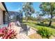 Relaxing outdoor patio with comfortable seating, lush greenery, and a screened-in lanai overlooking the backyard at 284 Talquin Ct, Englewood, FL 34223