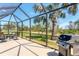 Enjoy the spacious screened-in patio with an outdoor kitchen and a beautiful view of the well-maintained backyard at 284 Talquin Ct, Englewood, FL 34223