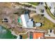 Birds eye view of the backyard featuring a pool, dock, lush landscaping and access to open water at 400 Anchor Row, Placida, FL 33946