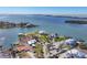 Picturesque aerial view of waterfront property featuring lush greenery, a dock, and a pool at 400 Anchor Row, Placida, FL 33946
