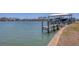 Waterfront view of private dock with boat parked underneath the canopy at 400 Anchor Row, Placida, FL 33946