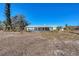 Rear exterior of home showing pool, patio, and yard with bay views at 400 Anchor Row, Placida, FL 33946