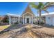 Home's entryway features a modern door, a covered porch, and manicured greenery at 400 Anchor Row, Placida, FL 33946