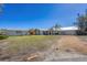 Inviting home exterior with gravel driveway and tropical landscaping, showcasing a bright and welcoming facade at 400 Anchor Row, Placida, FL 33946