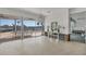 Light-filled living room with waterfront views and terrazzo flooring provides a seamless indoor-outdoor living experience at 400 Anchor Row, Placida, FL 33946