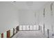 Open room featuring white walls, terrazzo floors, and exposed studs for renovation at 400 Anchor Row, Placida, FL 33946
