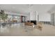 Open living room with a fireplace, terrazzo floor, and waterfront views creates an inviting and airy atmosphere at 400 Anchor Row, Placida, FL 33946