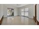 Sunlit living room with terrazzo floors and large windows showcasing outdoor views at 400 Anchor Row, Placida, FL 33946