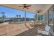 Covered patio with ceiling fans, poolside seating, and serene waterfront views at 400 Anchor Row, Placida, FL 33946