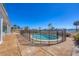Backyard view of fenced in kidney bean shaped pool surrounded by concrete patio at 400 Anchor Row, Placida, FL 33946