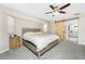 Bedroom featuring carpeted floors, ceiling fan, natural lighting, and a wooden barn door at 4405 Boggs St, Port Charlotte, FL 33948