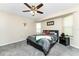 Bedroom showcasing carpeted floors, ceiling fan, bedside table, art piece and natural lighting at 4405 Boggs St, Port Charlotte, FL 33948