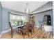 Bright dining room featuring a glass table, bay window and decorative chandelier at 4405 Boggs St, Port Charlotte, FL 33948