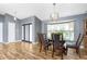 Dining room with wood floors, bay window with natural light, and chandelier lighting at 4405 Boggs St, Port Charlotte, FL 33948