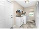 Efficient laundry room featuring modern appliances, a utility sink, and plenty of storage space at 4405 Boggs St, Port Charlotte, FL 33948