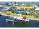 Aerial view of the property with a pool, dock, boat lift, and easy access to the water at 471 Capri Isles Ct, Punta Gorda, FL 33950
