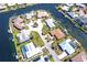 Stunning aerial view of a waterfront home with a private pool and boat dock on a sunny day at 471 Capri Isles Ct, Punta Gorda, FL 33950
