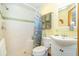 Bright bathroom featuring a tile shower, tropical decor and a single vanity at 471 Capri Isles Ct, Punta Gorda, FL 33950