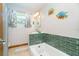 Bathroom with a tub and shower combo featuring tile surround, natural light and a vanity at 471 Capri Isles Ct, Punta Gorda, FL 33950