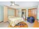 Comfortable bedroom featuring a pull-down bed and adjoining bathroom at 471 Capri Isles Ct, Punta Gorda, FL 33950