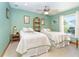 Cozy bedroom featuring two twin beds, tile floors, and a ceiling fan at 471 Capri Isles Ct, Punta Gorda, FL 33950