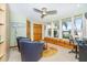 Bonus room features ample windows, custom built-ins, comfortable chairs, and a ceiling fan at 471 Capri Isles Ct, Punta Gorda, FL 33950