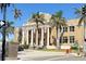 Classic courthouse exterior with tall columns, American flags, and palm trees against a clear sky at 471 Capri Isles Ct, Punta Gorda, FL 33950