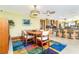 Dining room with colorful rug adjacent to open concept kitchen and bar seating at 471 Capri Isles Ct, Punta Gorda, FL 33950