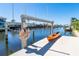 Waterfront dock with boat lift and kayak in a sunny canal community at 471 Capri Isles Ct, Punta Gorda, FL 33950