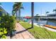 Beautiful waterfront backyard featuring a private dock, kayak, and outdoor seating at 471 Capri Isles Ct, Punta Gorda, FL 33950