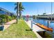 Waterfront backyard featuring a private dock, boat lift, kayak, and lounge chairs at 471 Capri Isles Ct, Punta Gorda, FL 33950