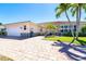 Charming single-story home with a brick driveway, well-manicured lawn, and a two-car garage at 471 Capri Isles Ct, Punta Gorda, FL 33950