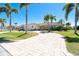 Single-story home with a circular driveway and tropical landscaping in a waterfront community at 471 Capri Isles Ct, Punta Gorda, FL 33950