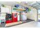 Well-organized garage with washer, dryer, fridge, and plenty of overhead storage at 471 Capri Isles Ct, Punta Gorda, FL 33950
