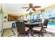 Screened-in lanai with dining table, connects to kitchen and overlooks the pool at 471 Capri Isles Ct, Punta Gorda, FL 33950