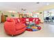 Open-concept living space featuring tile flooring and a large sectional sofa for comfortable gatherings at 471 Capri Isles Ct, Punta Gorda, FL 33950