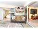 Comfortable sunroom with a couch, television and sliding glass door access to other rooms at 471 Capri Isles Ct, Punta Gorda, FL 33950
